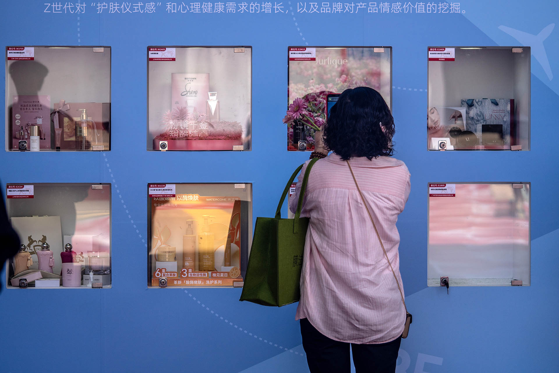 Female visitor observes products displayed in BCE showcase