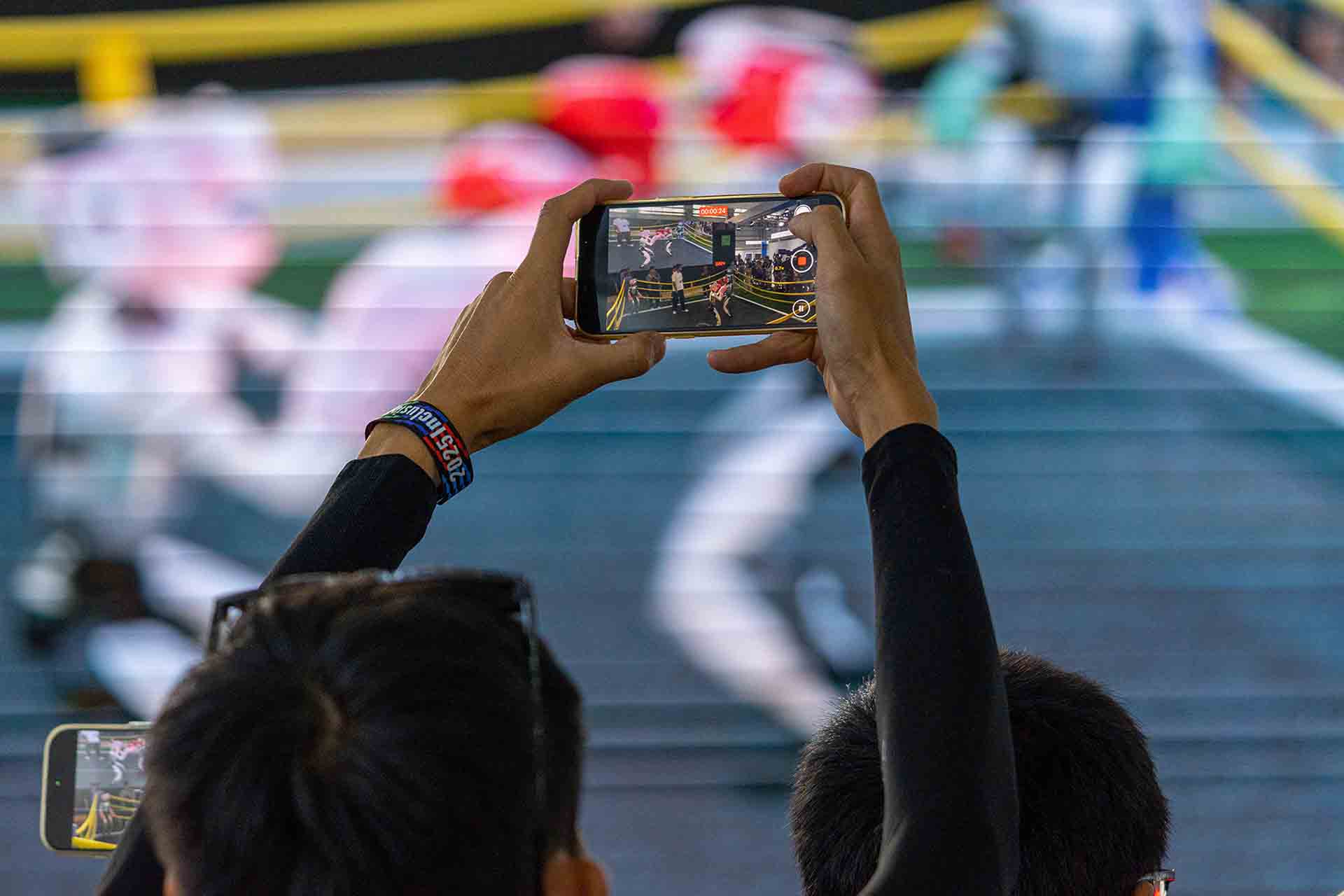 Visitor takes video to a robot boxing match