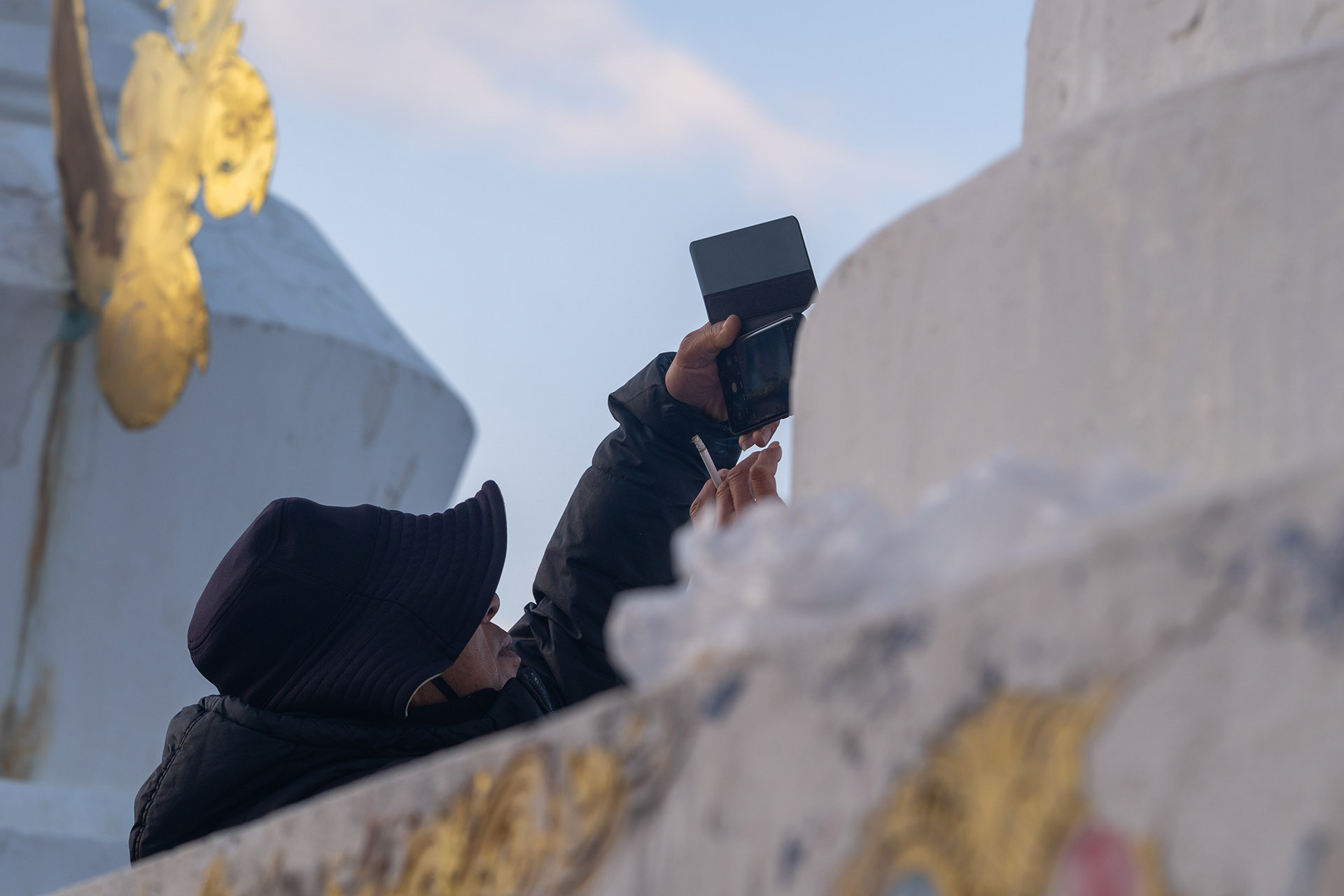 Visitor taking photo of sunrise on mountain