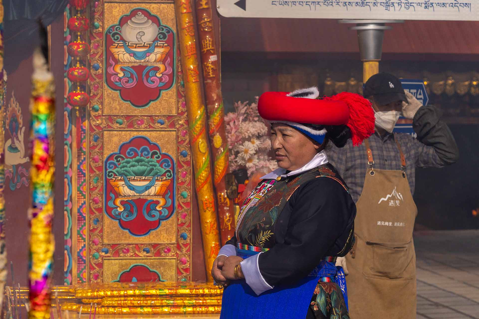 Woman in traditional attire observing the mountain