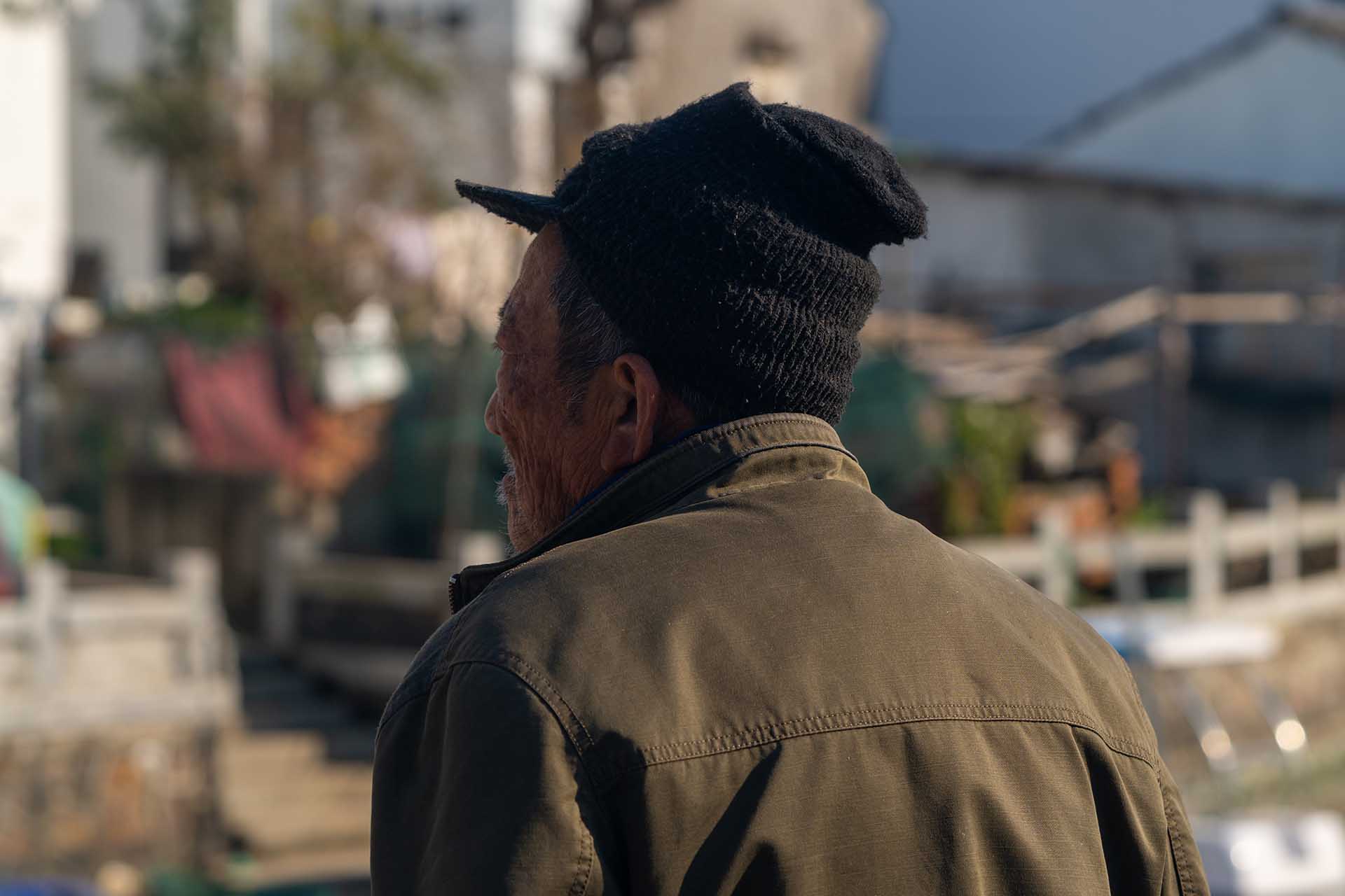 Local man gazing at village landscape